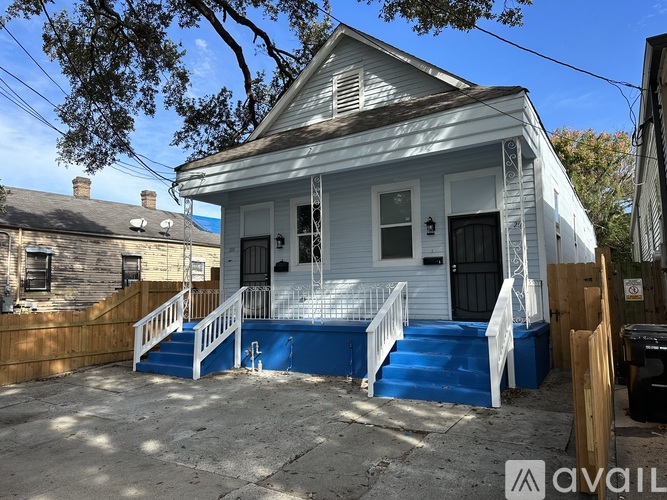 A white house with a blue staircase.