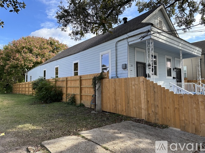 A house with a blue exterior and a wooden fence.