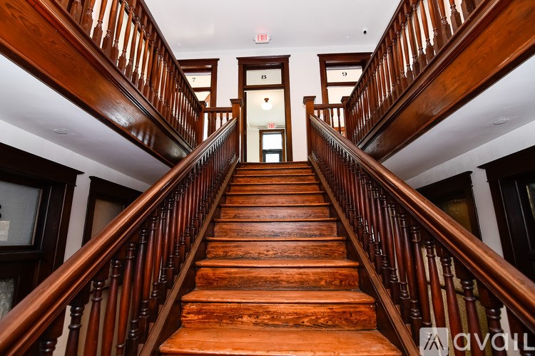 A long flight of wooden stairs leads to a door at the top.