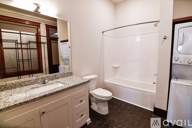 A bathroom with a toilet, sink, and shower.