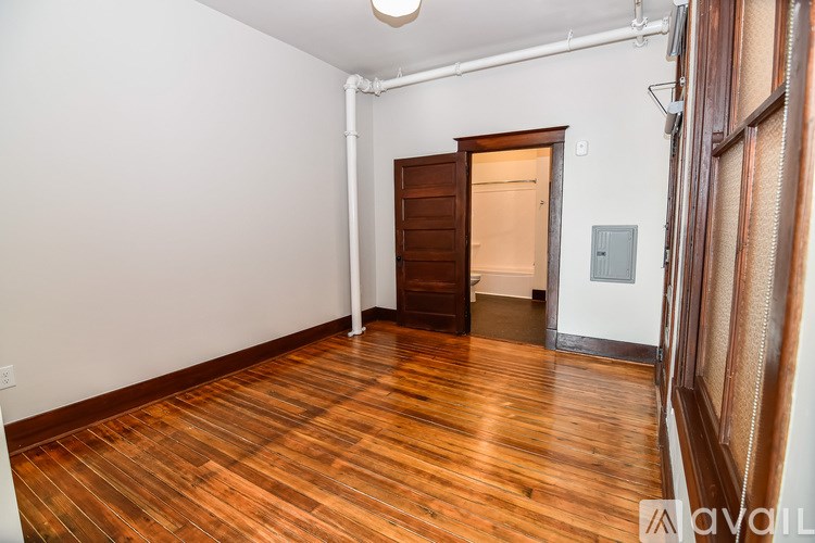 A room with wooden floors and a white door.