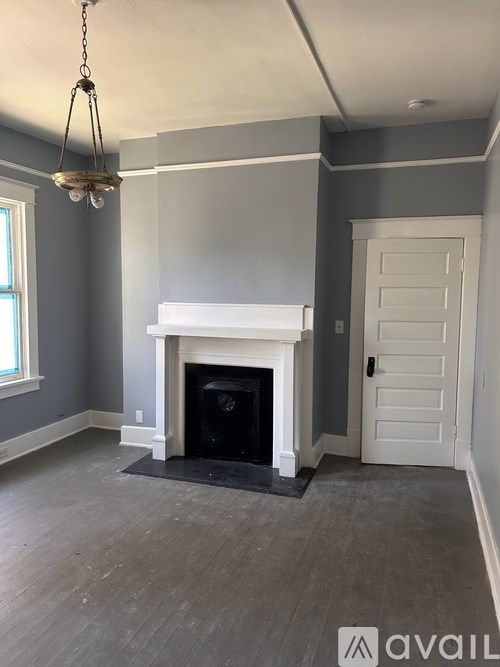 A room with a fireplace and a chandelier.