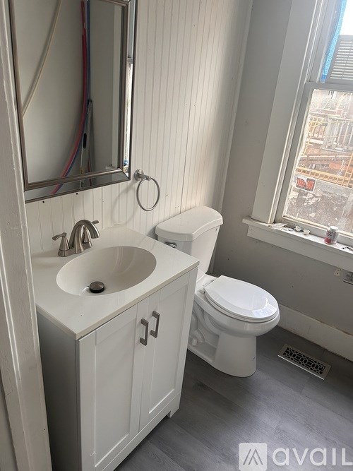 A bathroom with a white toilet and sink.