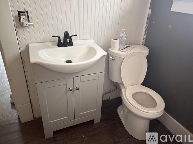 A white sink and toilet in a bathroom.
