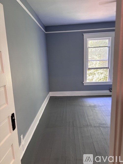 A room with a window and a door.