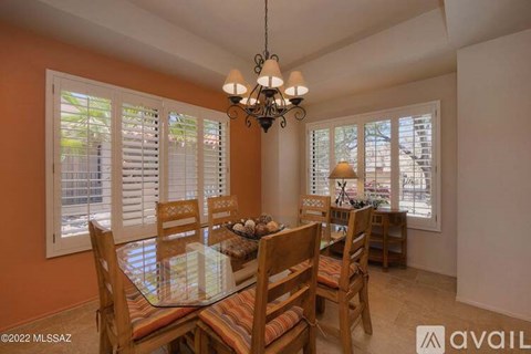 A dining room with a glass table and chairs.