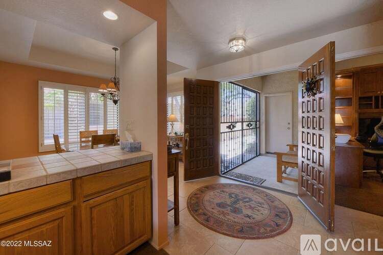 A kitchen with wooden cabinets and a tiled countertop.