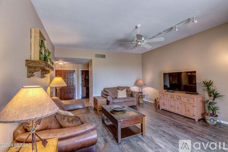 A living room with a brown leather couch and a wooden coffee table.
