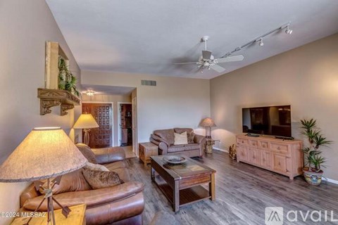 A living room with a brown leather couch and a wooden coffee table.