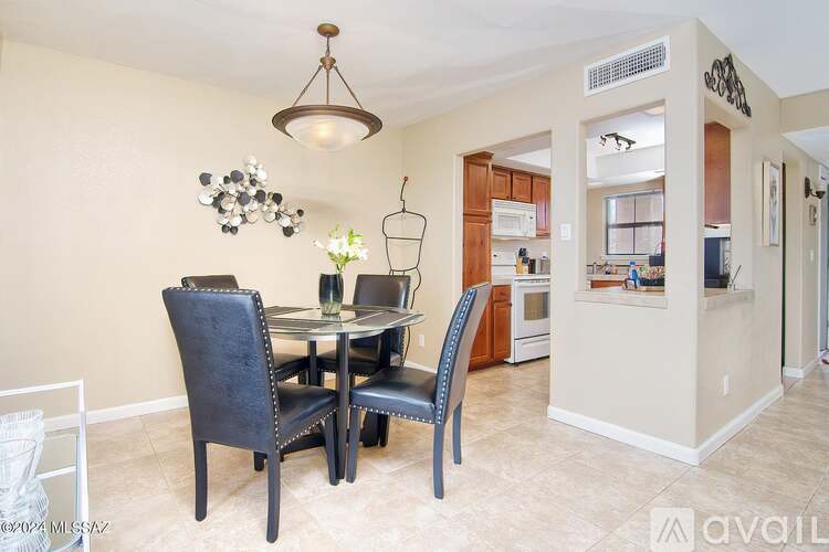 A dining room with a table and chairs.