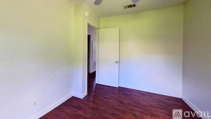 A room with a wooden floor and white walls.