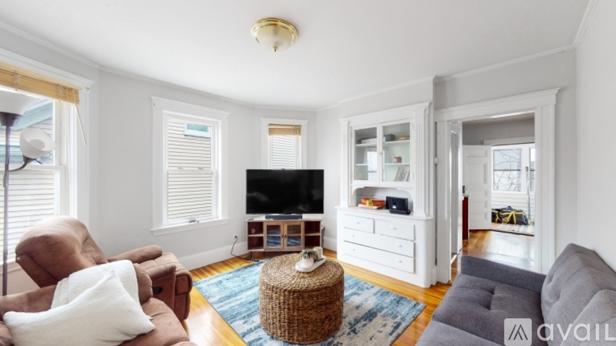 A living room with a brown chair and a grey sofa.