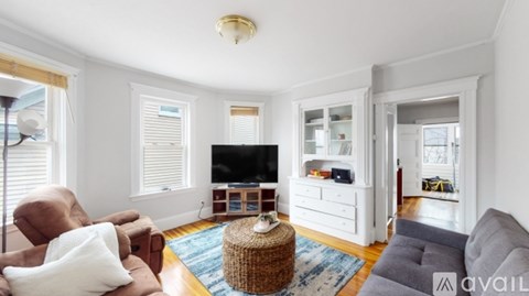 A living room with a brown chair and a grey sofa.