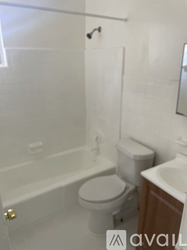 A white toilet is next to a bathtub in a bathroom.
