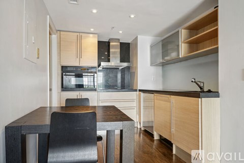 A modern kitchen with a dining table and chairs.