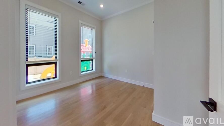A room with a window and wooden flooring is available for rent.