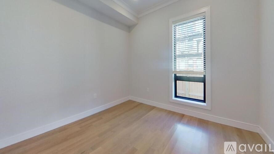 A room with a window and wooden flooring is available for rent.