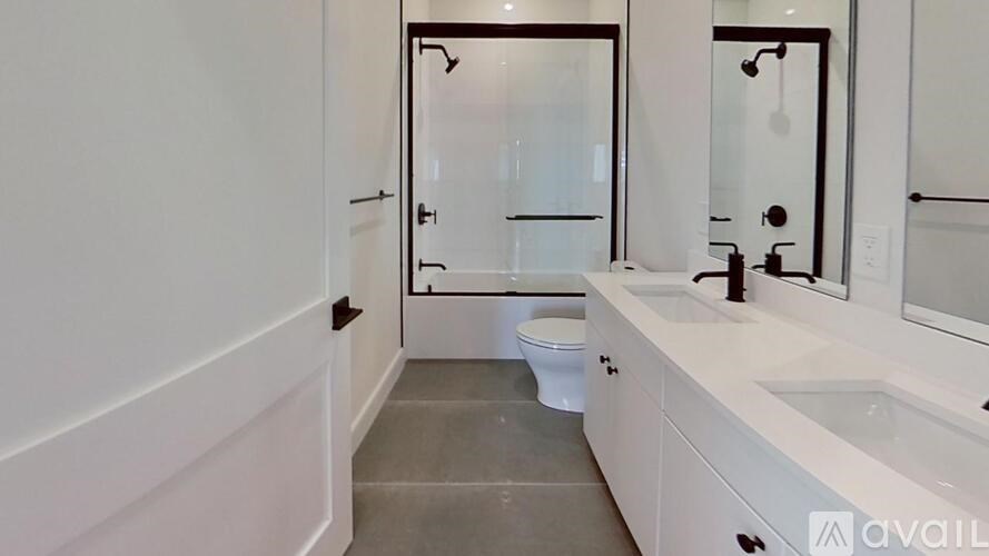 A bathroom with a toilet, sink, and mirror.