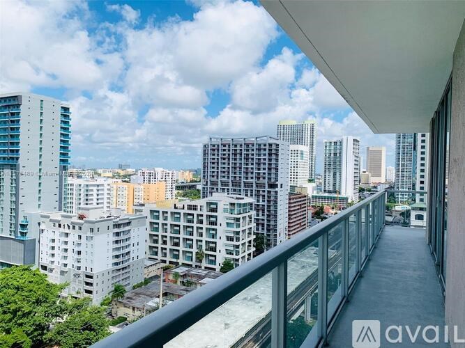 A balcony overlooks a cityscape with various buildings.
