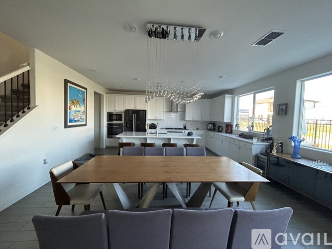 A modern kitchen with a dining table and chairs.