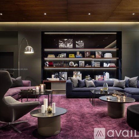 A modern living room with a purple carpet and a variety of furniture.