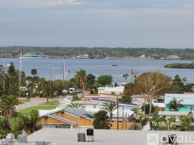 A view of a coastal area with buildings and a body of water.