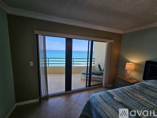 A shower stall with a blue towel hanging on the side.