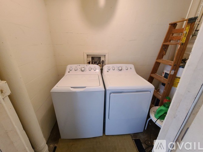 A small laundry room with a washer and dryer.