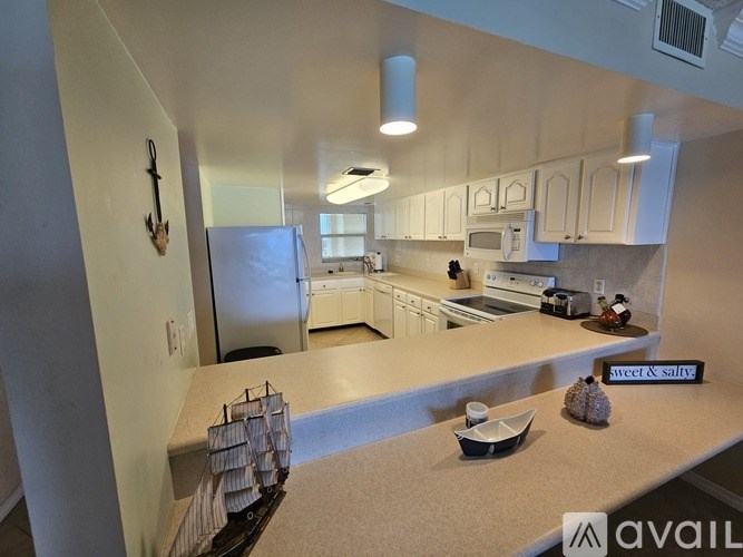 A kitchen with a sign that says "sweet & salty" on the counter.