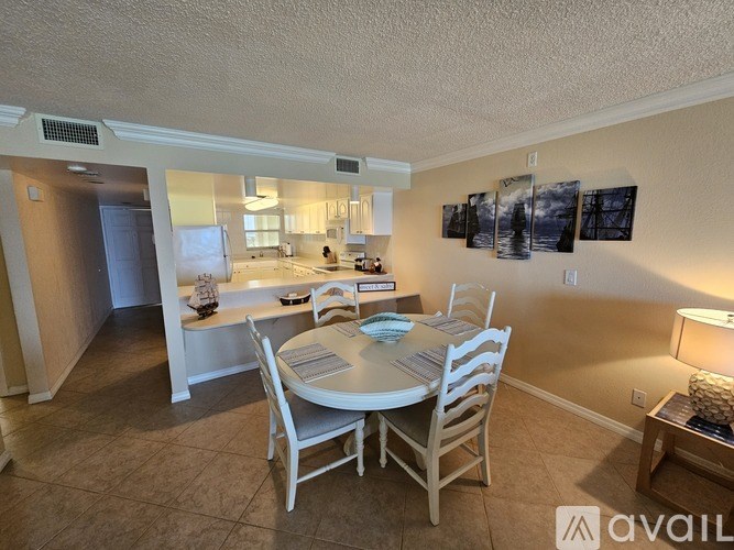A dining room with a table set for four.