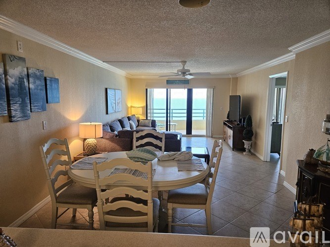 A living room with a dining table and chairs.