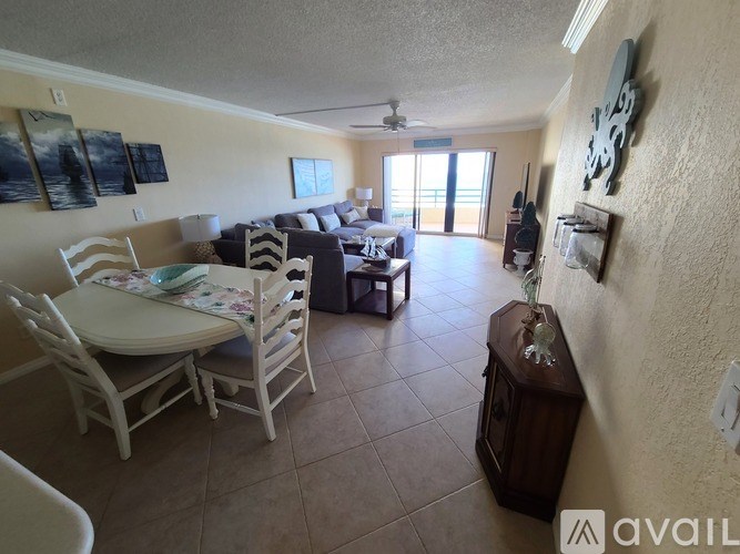 A living room with a dining table and chairs.