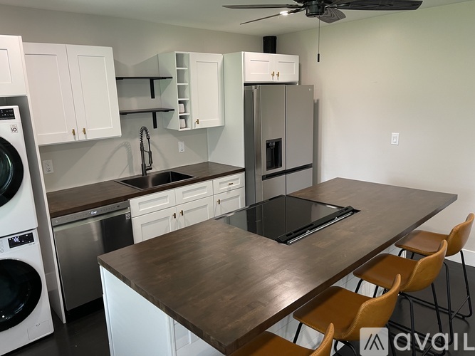 A kitchen with a table and chairs and a refrigerator.