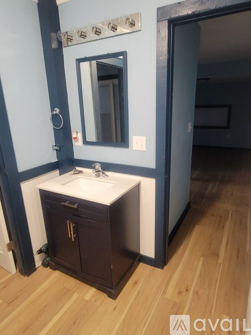A bathroom with a sink and a mirror.