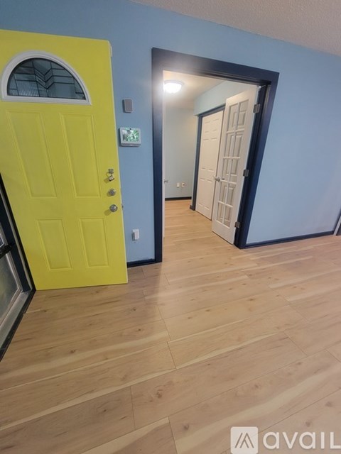 A yellow door is on the left and a white door is on the right.