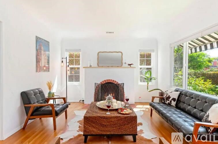 A living room with a fireplace, a couch, a chair, and a coffee table.