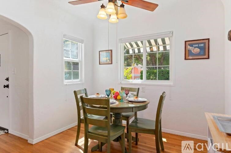 A dining room with a table set for four.