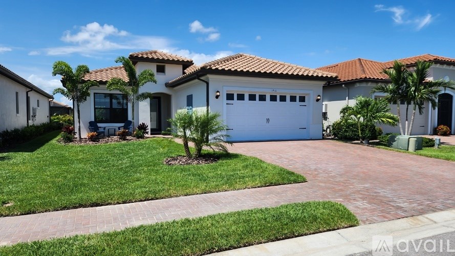A house with a red tiled roof and a white garage door is for sale.