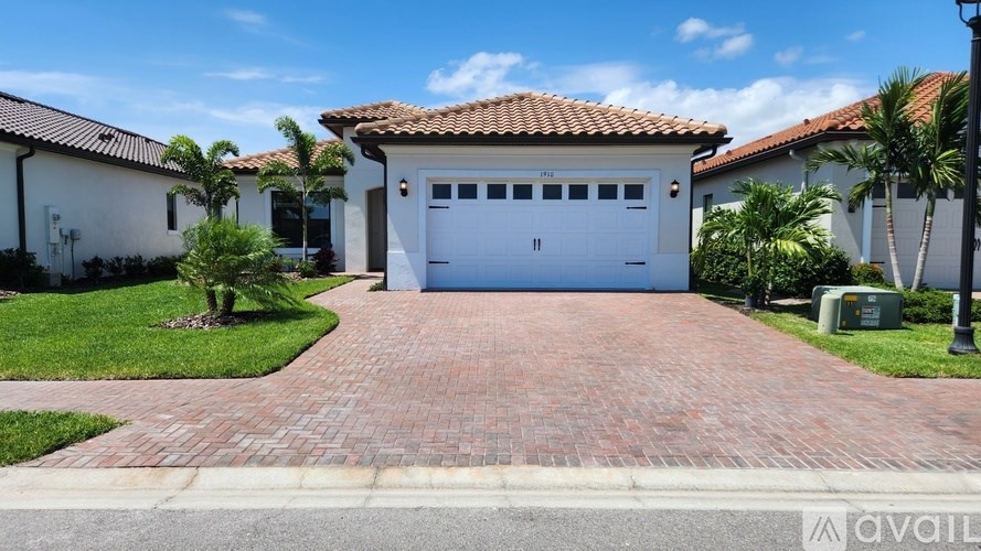 A house with a red tiled roof and a white garage door.