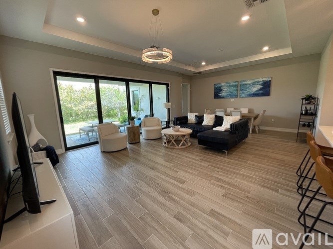 A living room with a television, couches, and a coffee table.