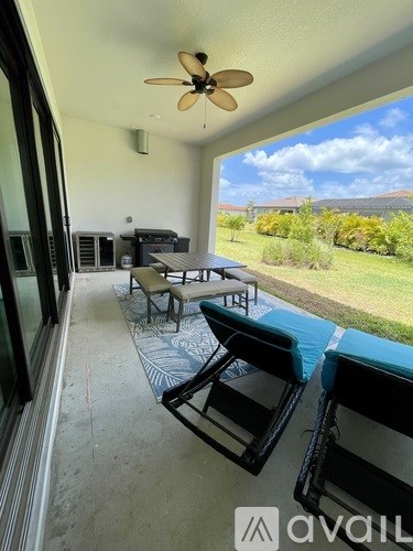 A patio with a table and chairs overlooking a garden.