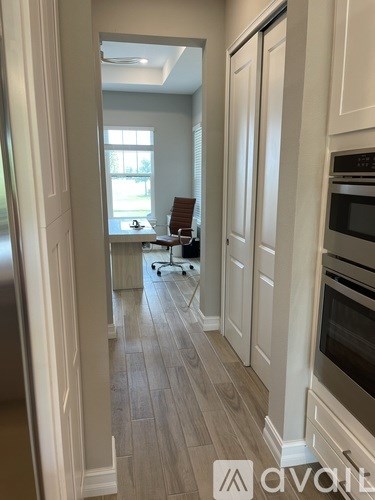 A kitchen with a refrigerator on the left and an oven on the right.