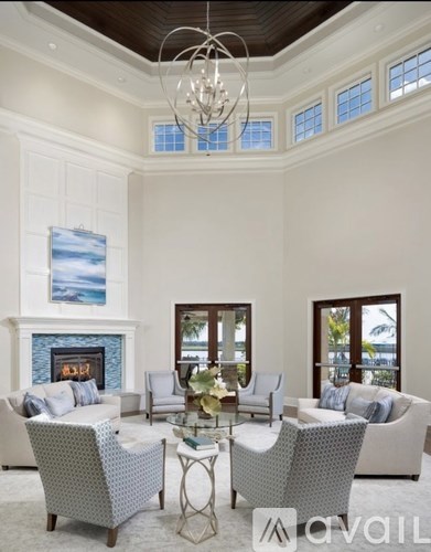 A living room with a fireplace and a painting on the wall.