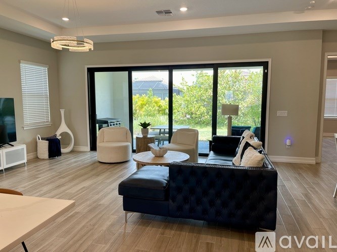 A living room with a black sofa and a coffee table.