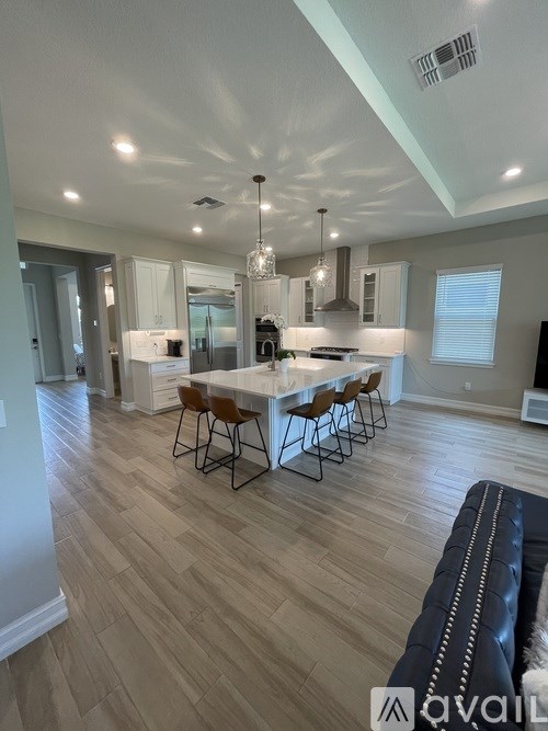 A modern kitchen with a dining table set for four.