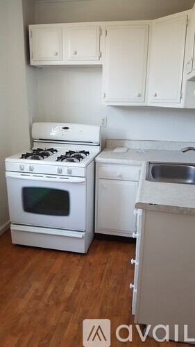 A kitchen with a white stove and a white dishwasher.