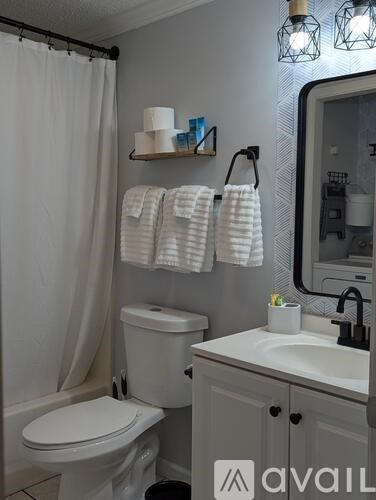 A white washing machine and dryer in a small laundry room.