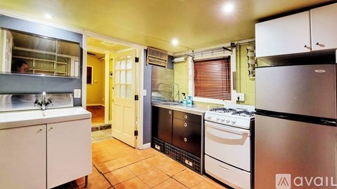 A kitchen with a stove, oven, and refrigerator.