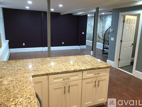 A kitchen with granite countertops and cabinets.
