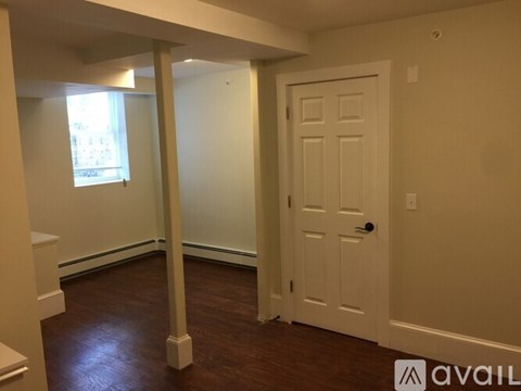 A room with a white door and a window with a white frame.